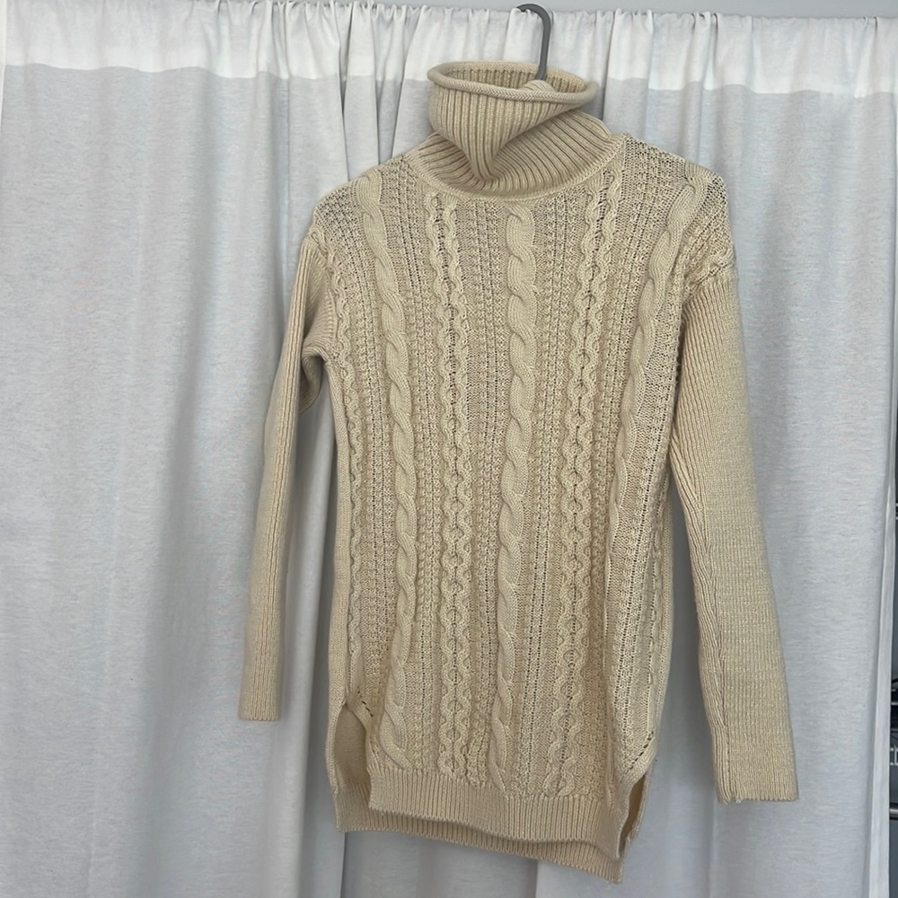 Cream colored turtleneck, classic sweater. Long but not a dress. Thick material!